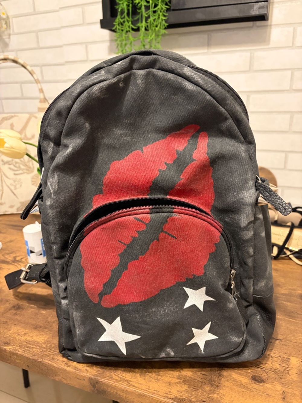 Black Canvas Backpack with Red Lip Graphic and White Star Accents